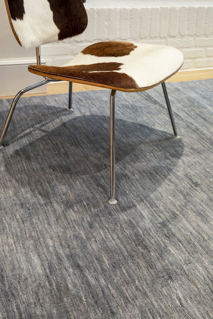 Rectangular area rug in blue and neutral tones, 5' x 8'.