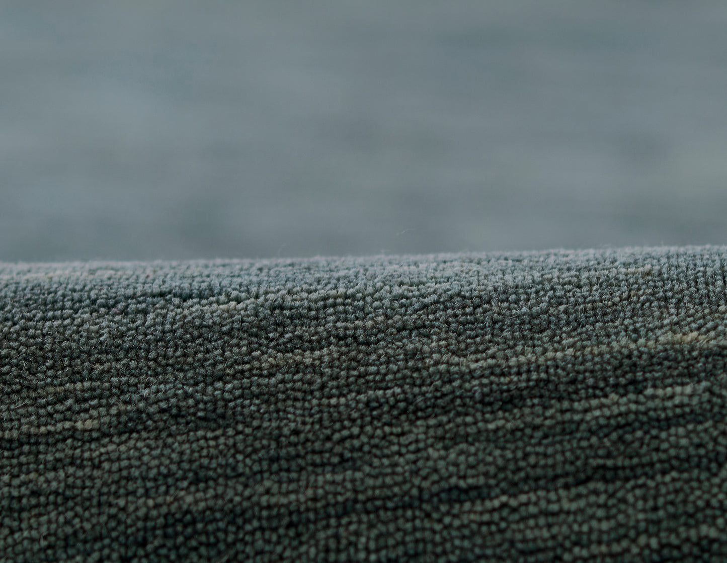 Blue boucle rug runner close-up showing tiny loop texture; dense, soft rug surface.