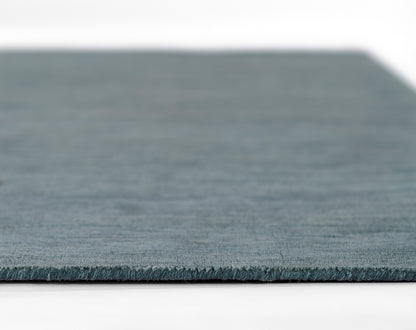 Blue-gray flat-weave runner with subtle texture and visible edge.