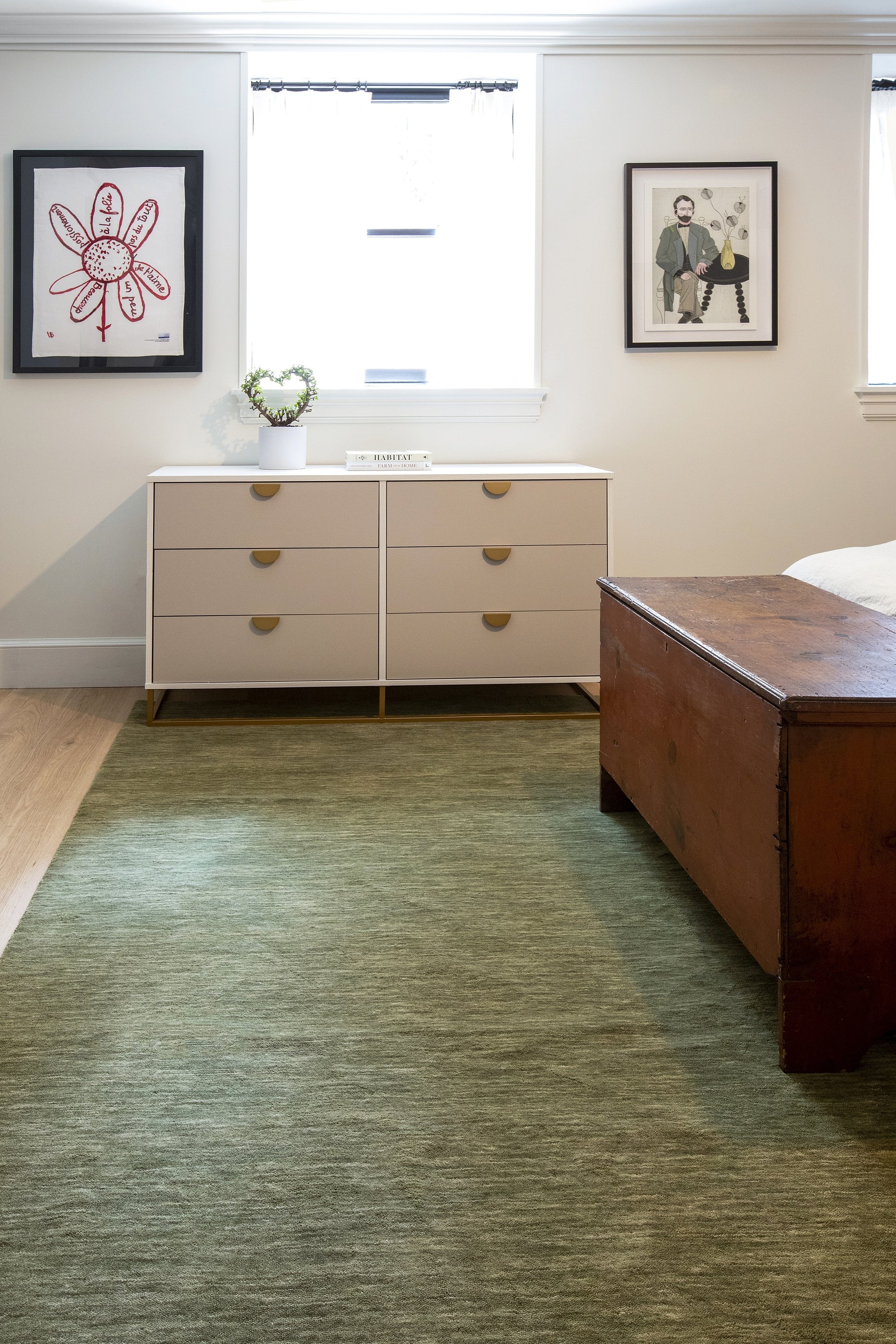 Green rug with a floral pattern.