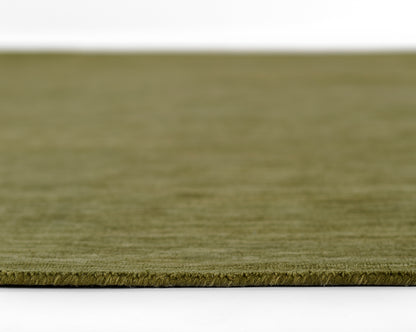 Olive green rug edge close-up; low-pile flat-weave with a tight border for modern living spaces.