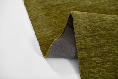 Olive green textured runner rug with gray underside; folded corner reveals plush pile, modern cozy decor.
