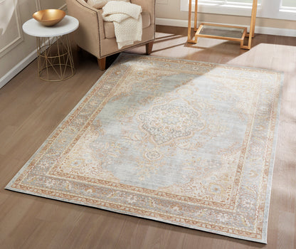 Rectangular area rug in pale blue, ivory and tan with an ornate medallion border and soft pile for the living room.