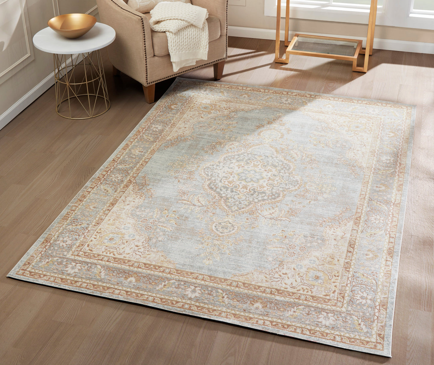 Runner rug with a faded blue and beige ornate pattern, beige border, on a light wood floor.