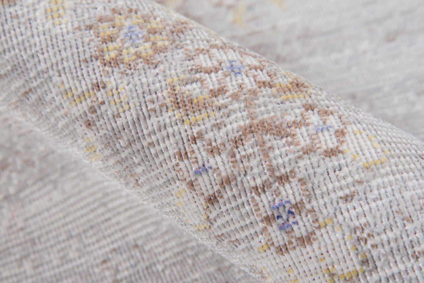 Gray woven rug with a subtle floral jacquard pattern in yellows, blues and browns, 9' x 12'.