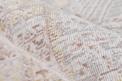 Beige-gray woven rug close-up with subtle yellow accents and geometric pattern.
