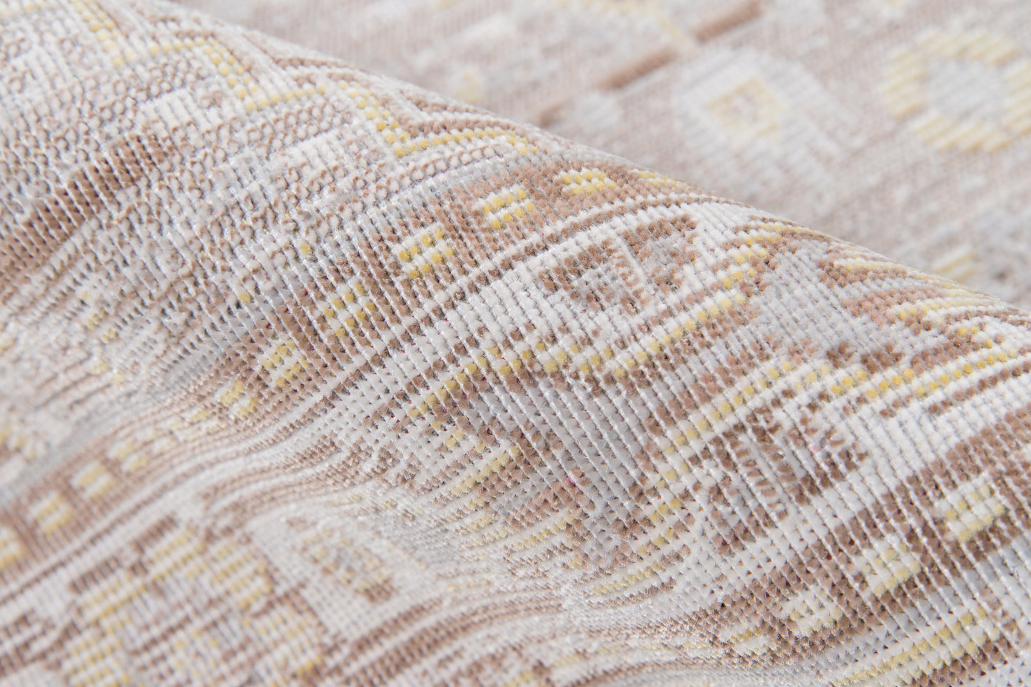 Gray-beige woven rug with geometric kilim pattern and subtle yellow accents.