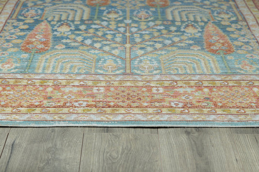 Blue-teal oriental runner with floral medallions and a warm orange border on gray wood flooring.