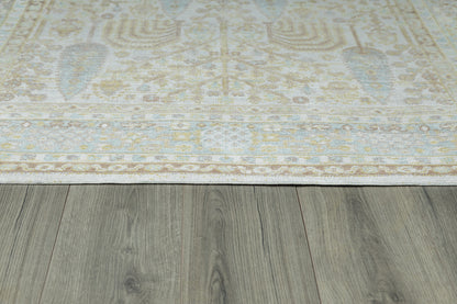 Ivory runner rug with a pale blue & beige floral motif on a gray wooden floor.