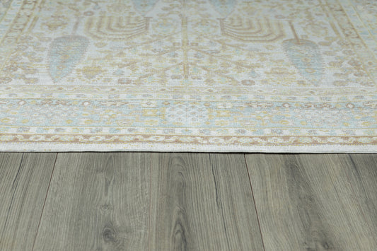 Ivory runner rug with a pale blue & beige floral motif on a gray wooden floor.