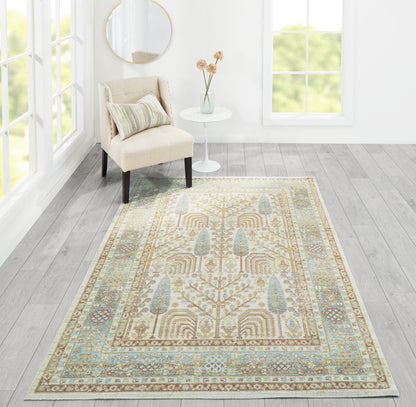Traditional oriental runner rug in cream, beige and blue tones, laid in a bright living room beside a cream chair and round white table.