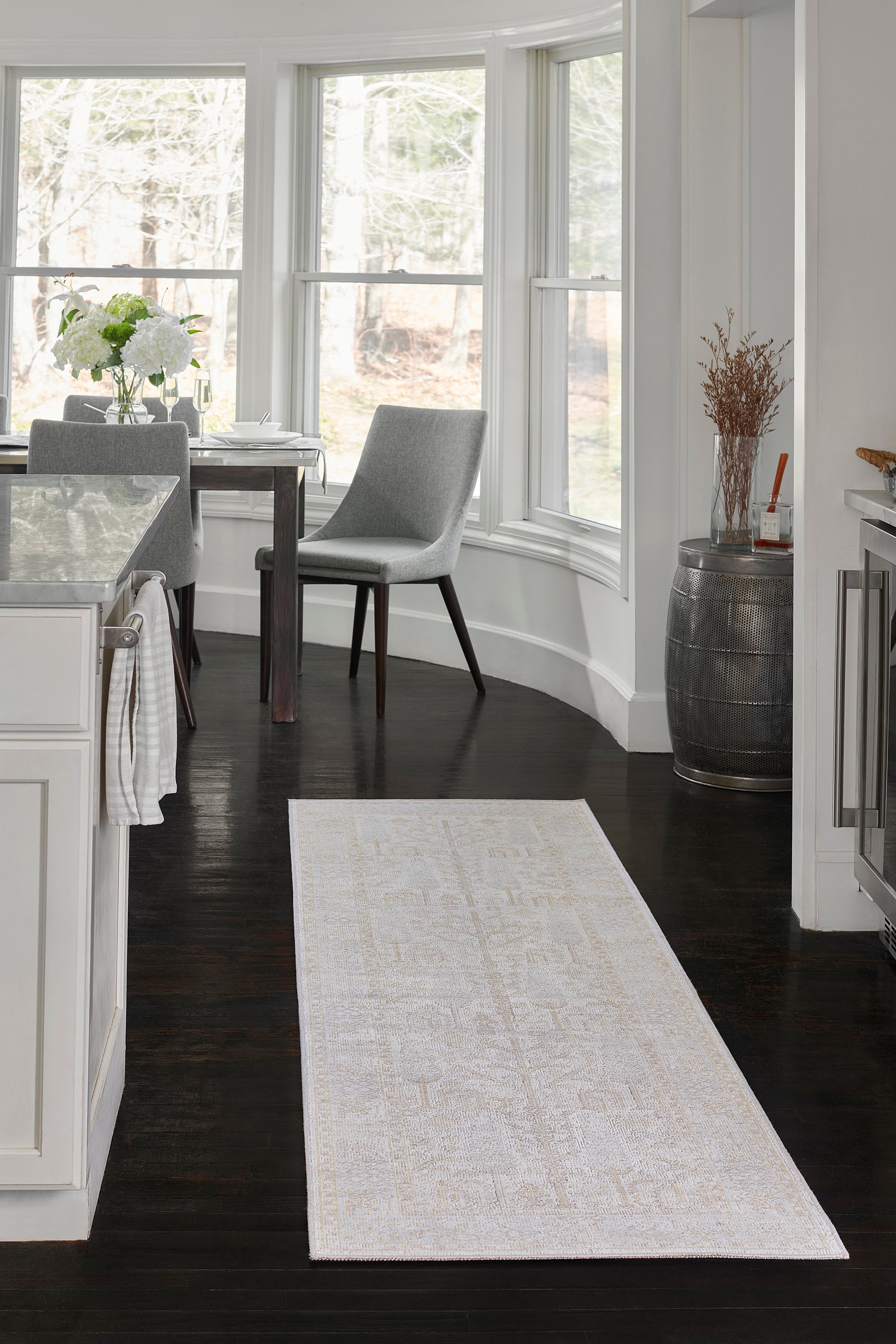 Ivory cream area rug with a subtle faded pattern; rectangular, suitable for dining/kitchen areas.