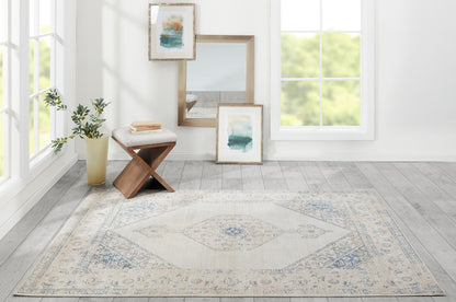 Rectangular ivory and pale blue rug with central medallion, subtle distressed pattern, ideal for living rooms.