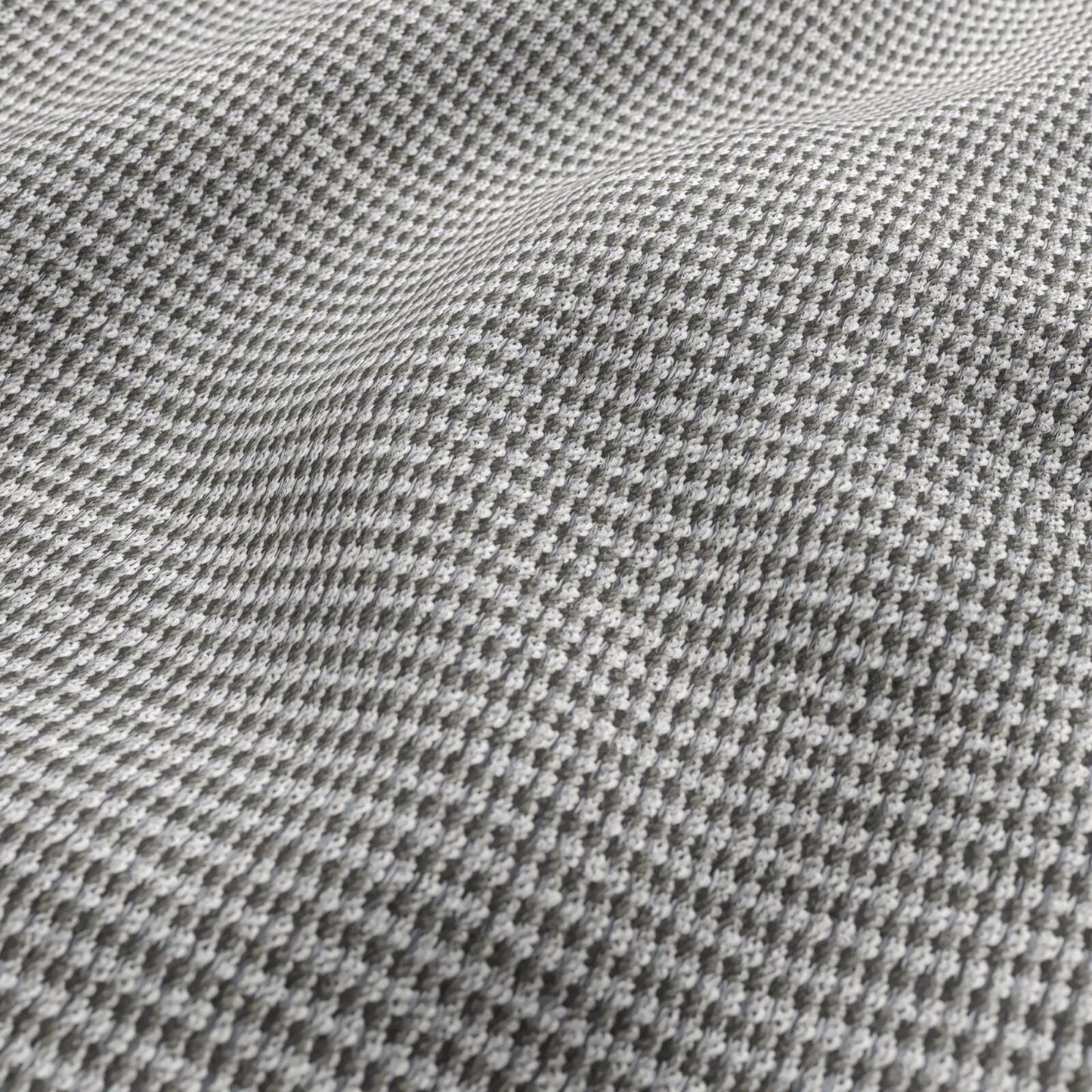 Close-up of grey chenille outdoor fabric texture with small raised dots; striped pattern in white, grey, black and beige.