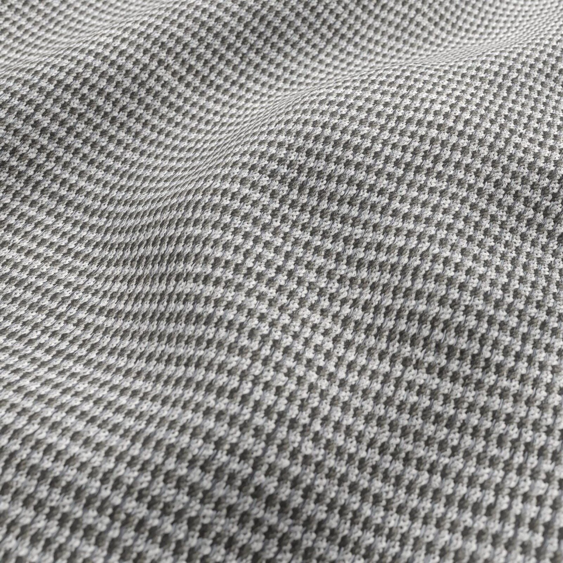 Close-up of grey chenille outdoor fabric texture with small raised dots; striped pattern in white, grey, black and beige.
