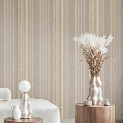 Beige striped wallpaper with white sculptural vases and pampas grass on round wooden stands, cozy bedroom decor