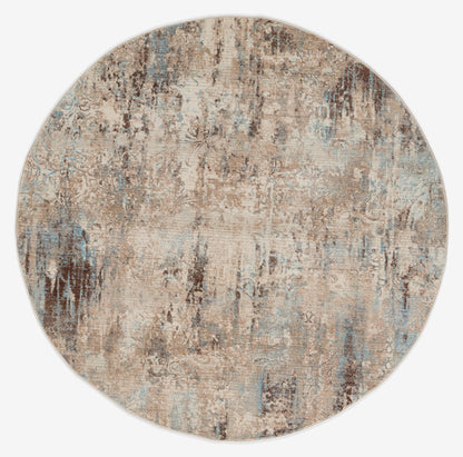 Round area rug with abstract distressed pattern in beige, taupe, blue and brown.