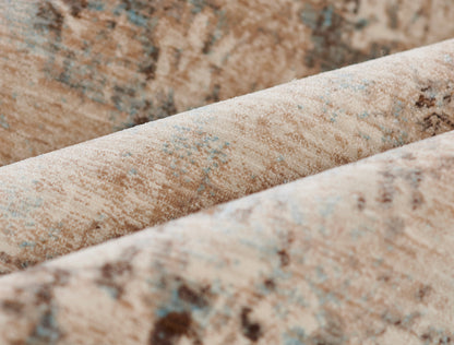 Close-up of beige oriental rug with blue accents, woven pile, folded edge.