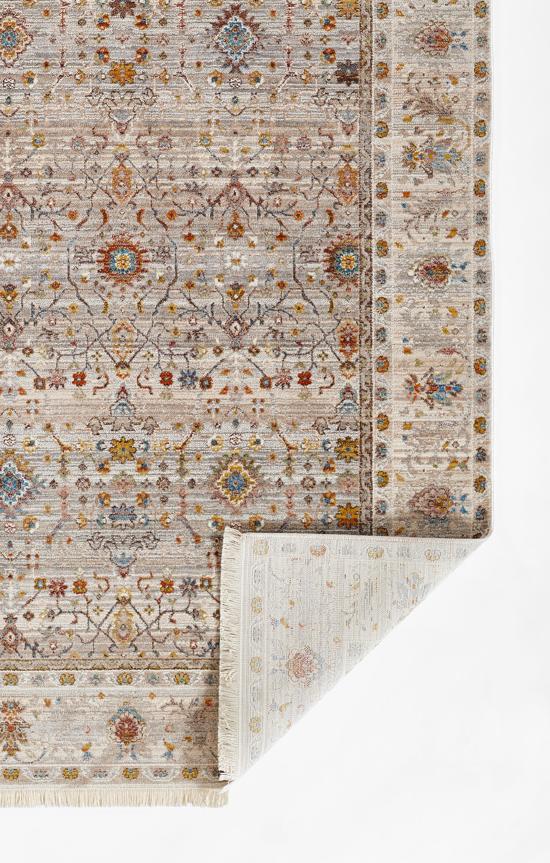Muted beige-gray oriental rug with blue and rust floral medallions and decorative border; folded corner.