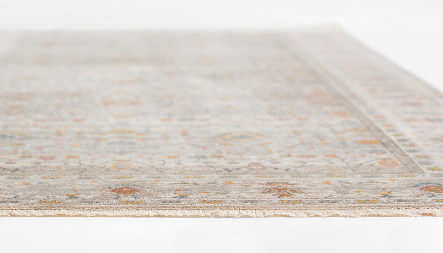 Rectangular light gray woven rug with subtle ivory and tan border motifs.