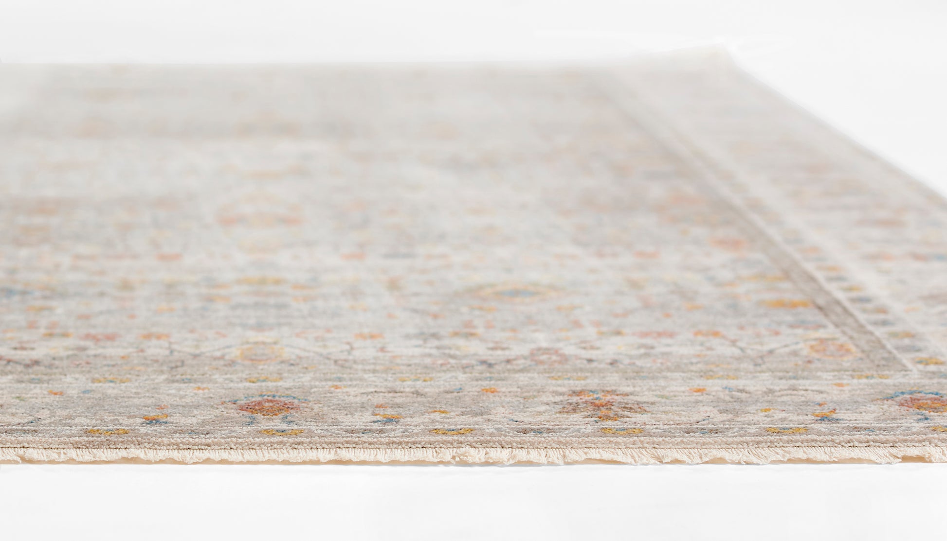 Rectangular light gray woven rug with subtle ivory and tan border motifs.