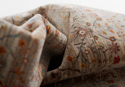 Gray floral rug with tiny orange, yellow and blue flowers; soft woven texture.