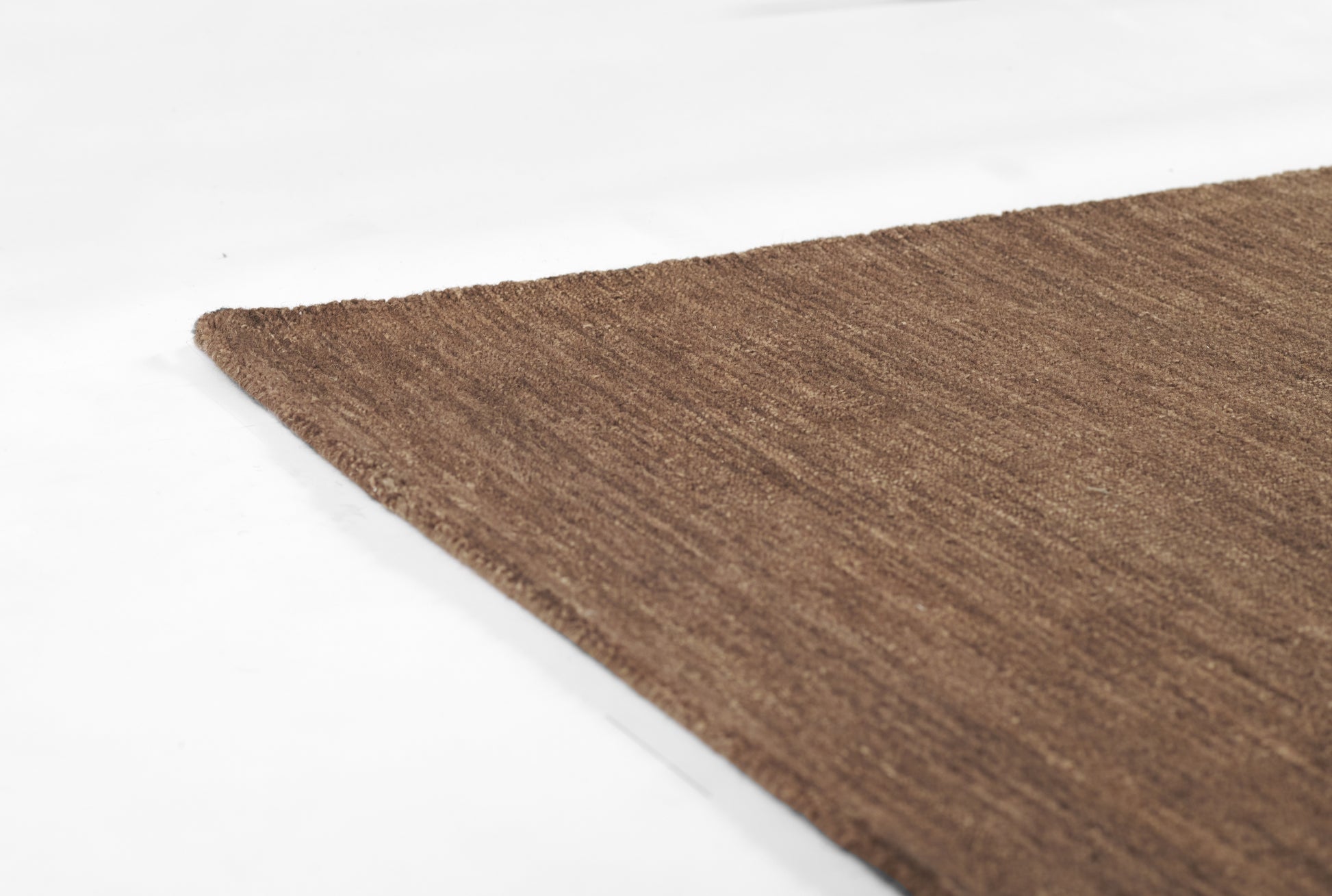 Brown textured flat-weave rug, rectangular rug for living spaces.