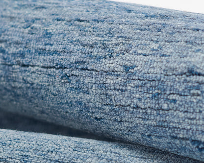 Close-up of blue denim-style rug pile with soft, dense woven texture.