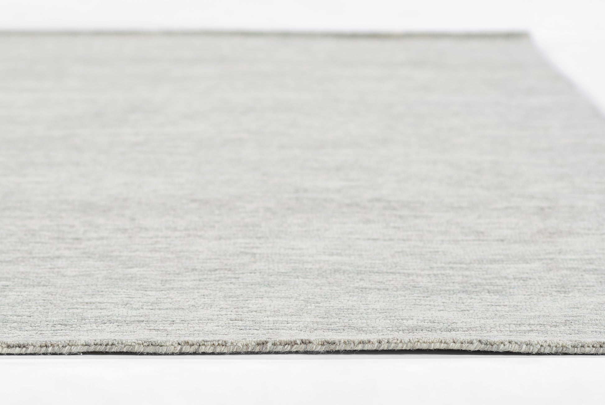 Light gray flatweave rug with subtle woven texture, rectangular, modern living-space decor.