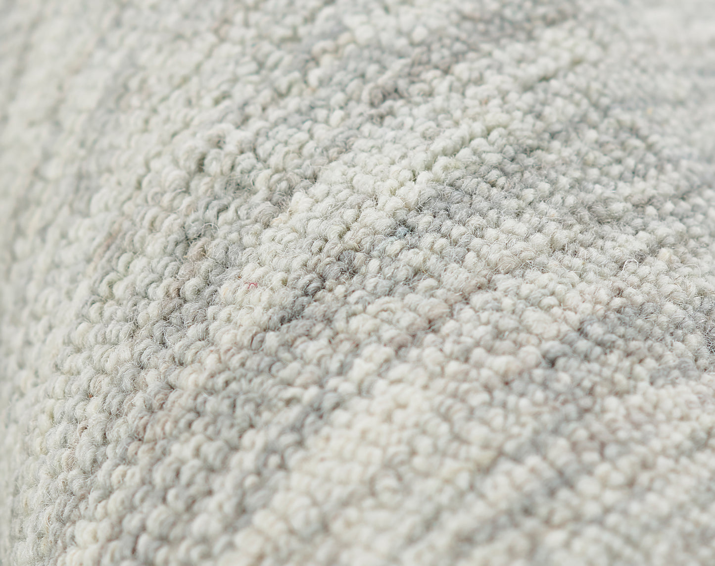 Close-up of a neutral gray-beige loop-pile rug with a soft woven texture, 3'6" x 5'6".
