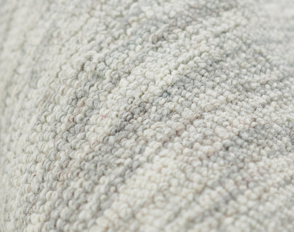Close-up of light gray-beige boucle rug fibers with dense loop pile.