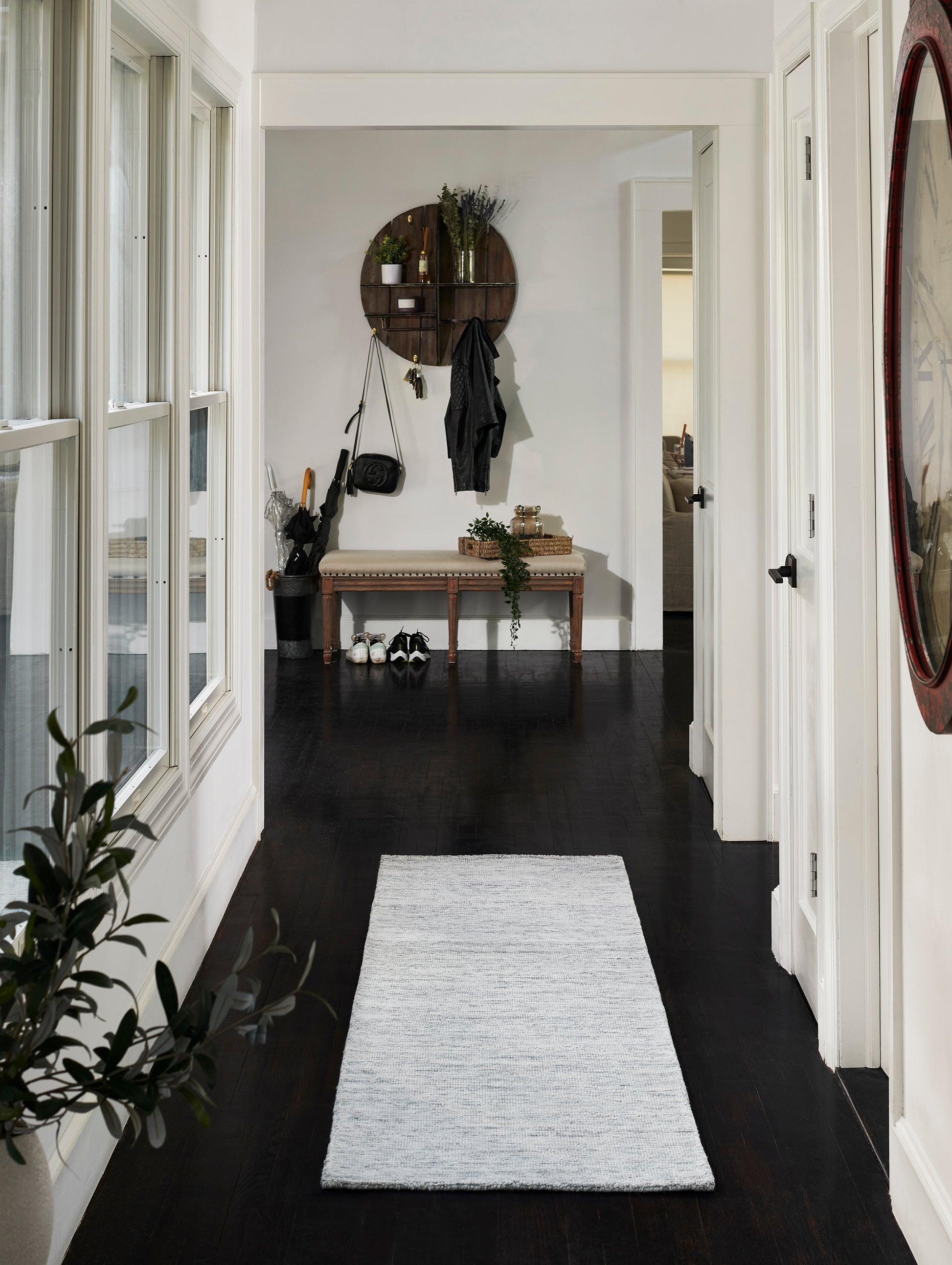 Light gray rectangular area rug (5' x 8') with subtle texture for a modern entryway on dark wood floors.