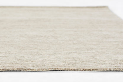Neutral beige jute rug close-up with natural woven texture and flat edge.