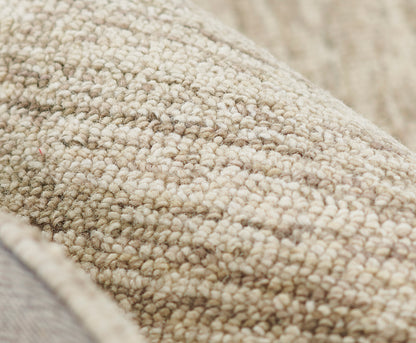 Beige boucle rug close-up with dense loop pile and natural warm texture.
