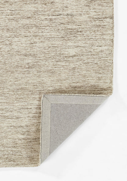 Natural beige textured rug with short pile; folded corner reveals grey backing.