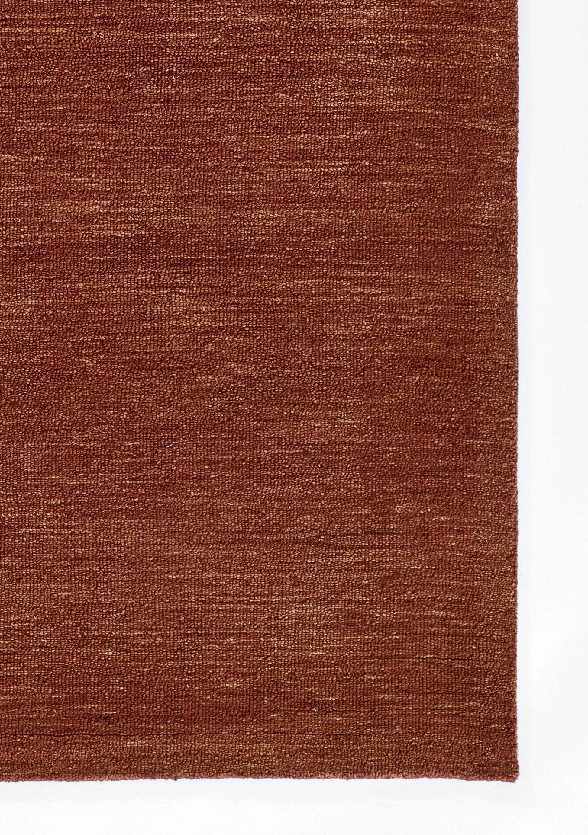 Rust-brown woven rug with subtle texture; rectangular indoor floor decor.