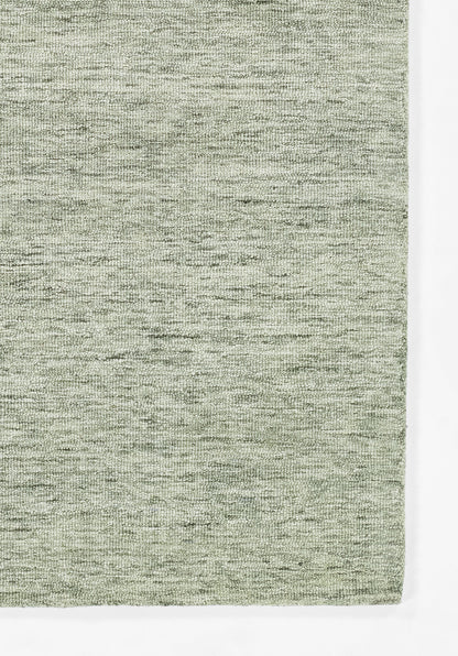 Sage green heathered woven rug, rectangular flat-weave with soft texture for living room use.
