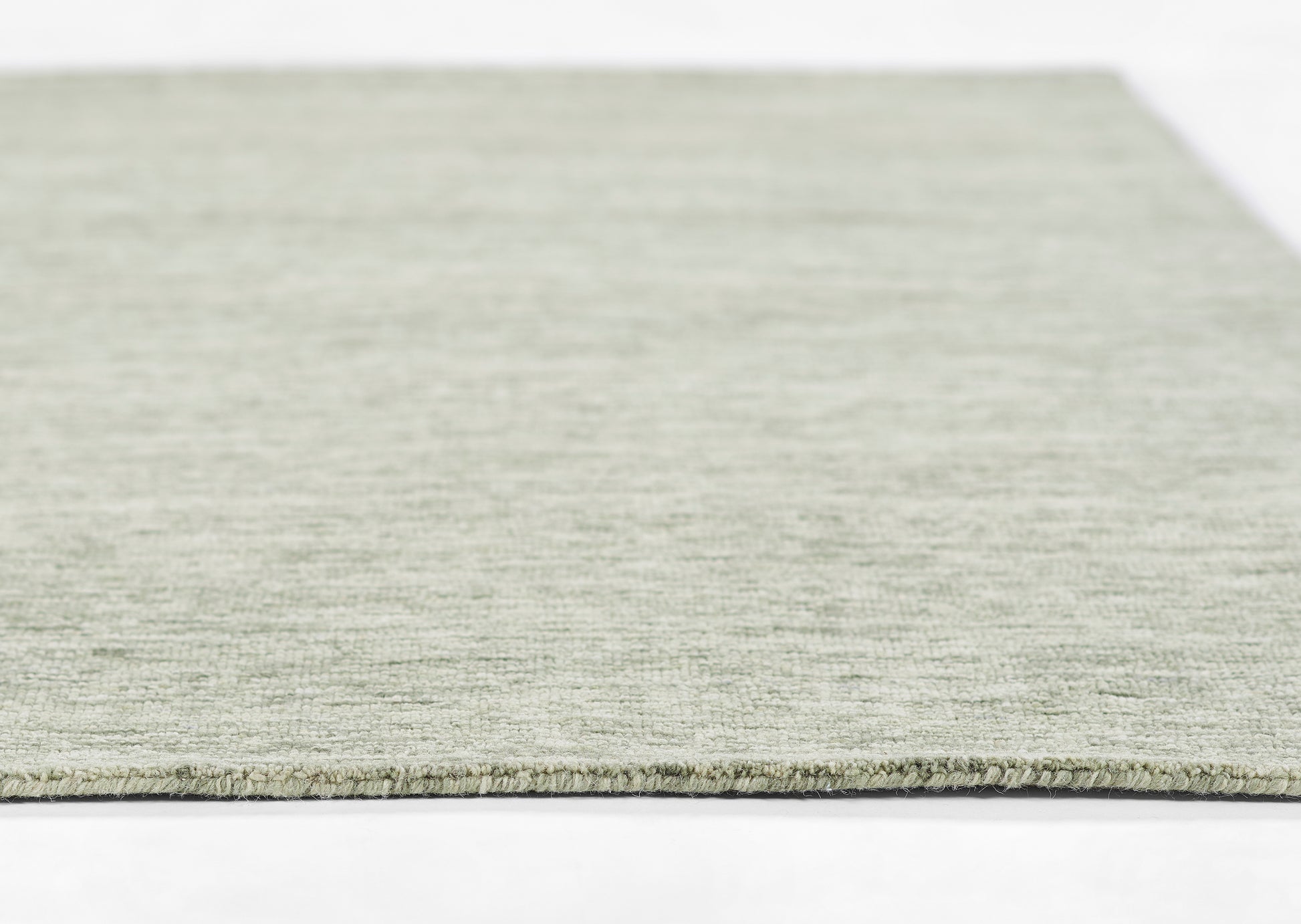 Rectangular sage gray flat-weave rug with short fringe; soft textured surface, modern minimalist style.