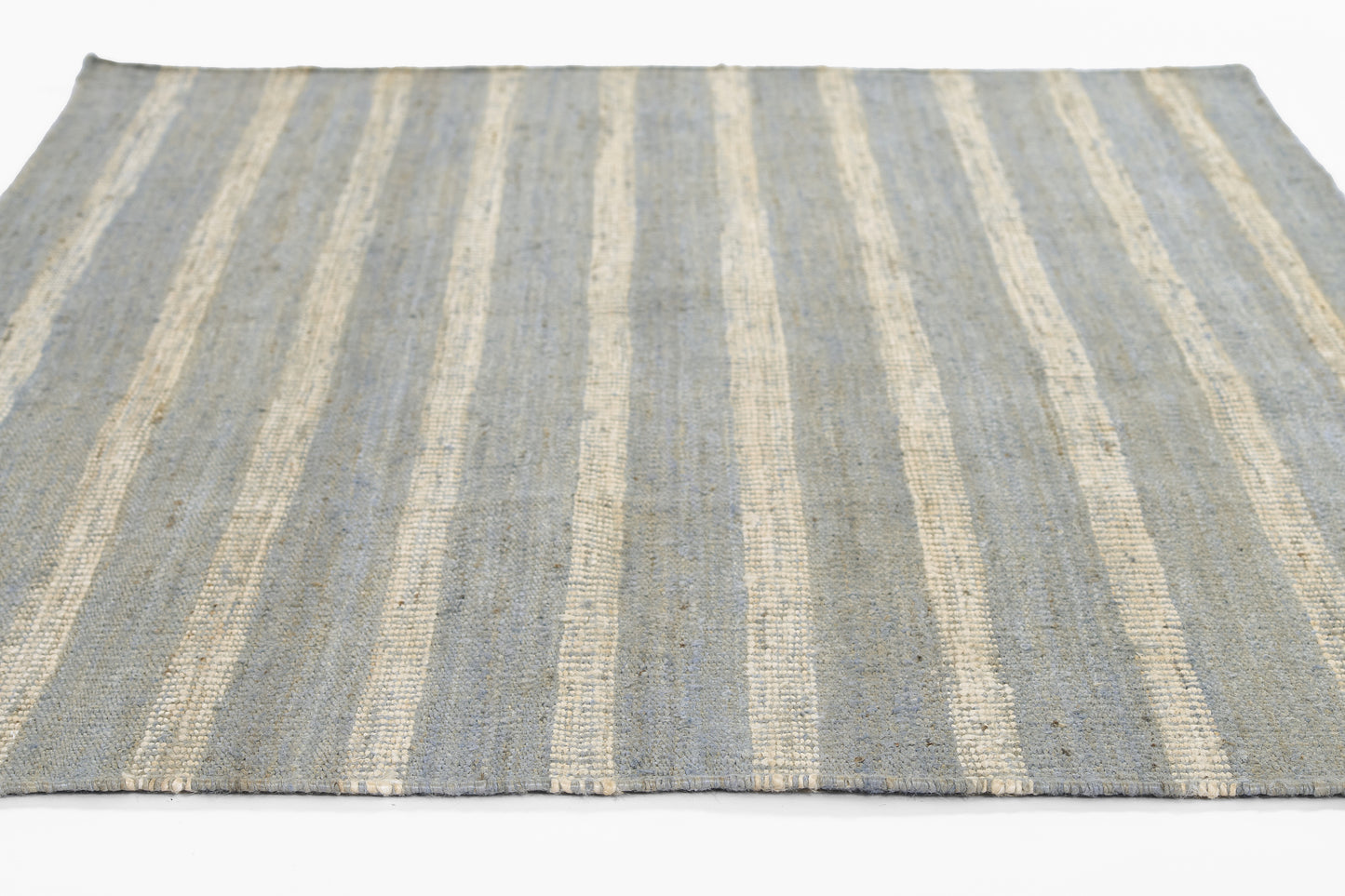 Rectangular textured flat-weave rug with blue & ivory stripes, casual coastal style.