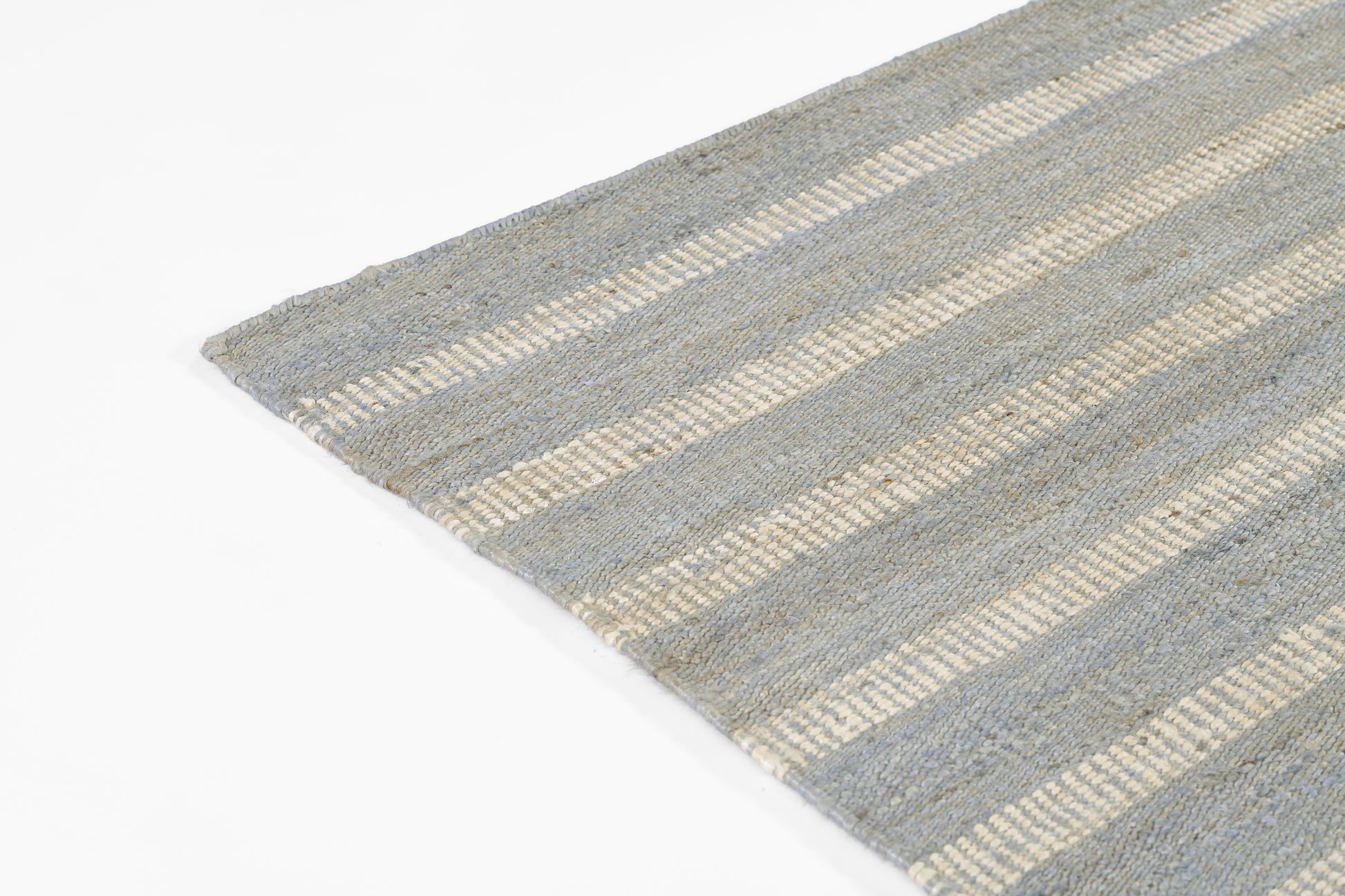 Gray-blue striped flat-weave rug with beige bands and visible woven texture.