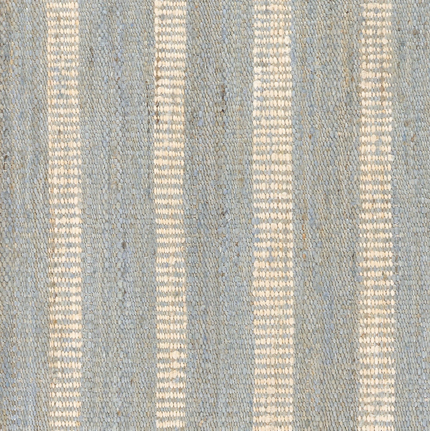 Blue woven rug with cream vertical stripes and textured surface.