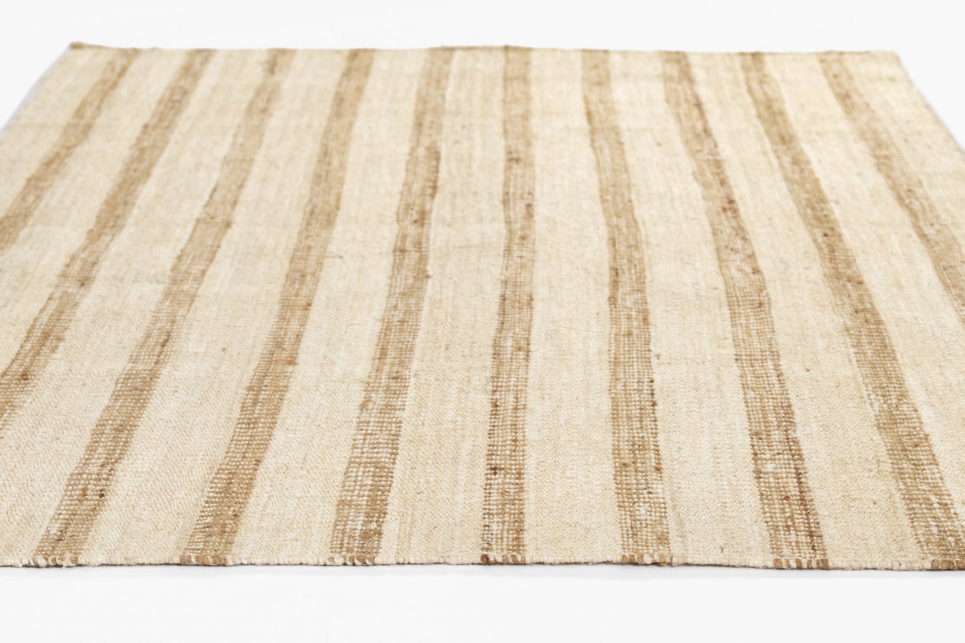 Beige flat-weave rug with vertical tan stripes; natural jute texture, rectangular for living room decor.