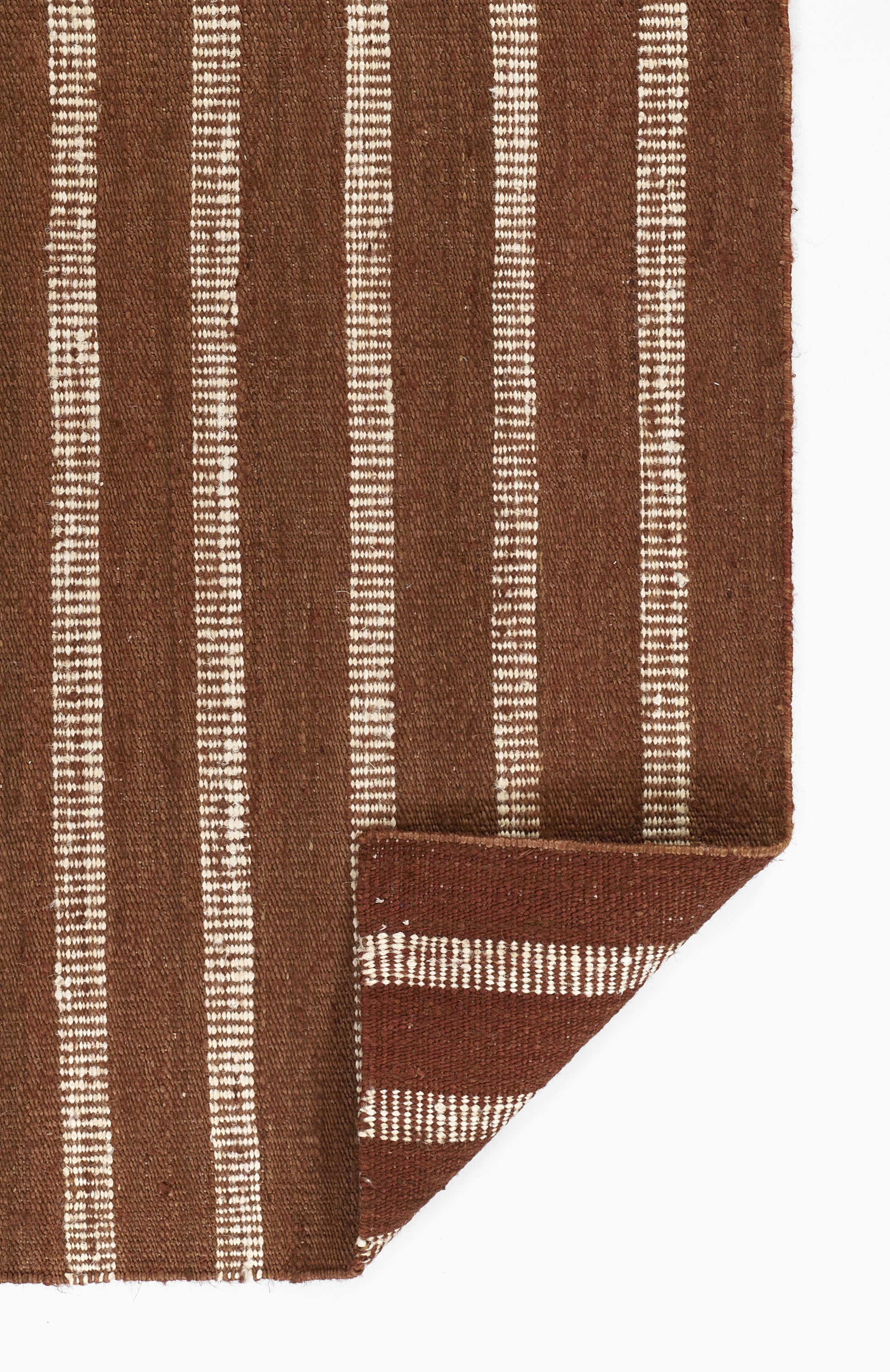 Brown striped rug with white vertical lines, folded corner detail, textile woven style.