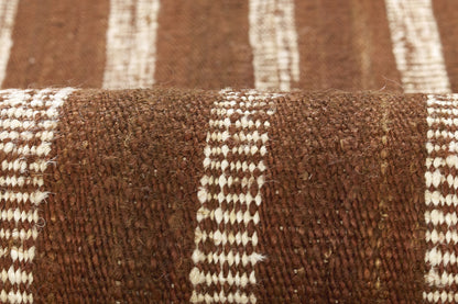 Brown and cream striped woven rug with chunky loop texture and rustic home decor.