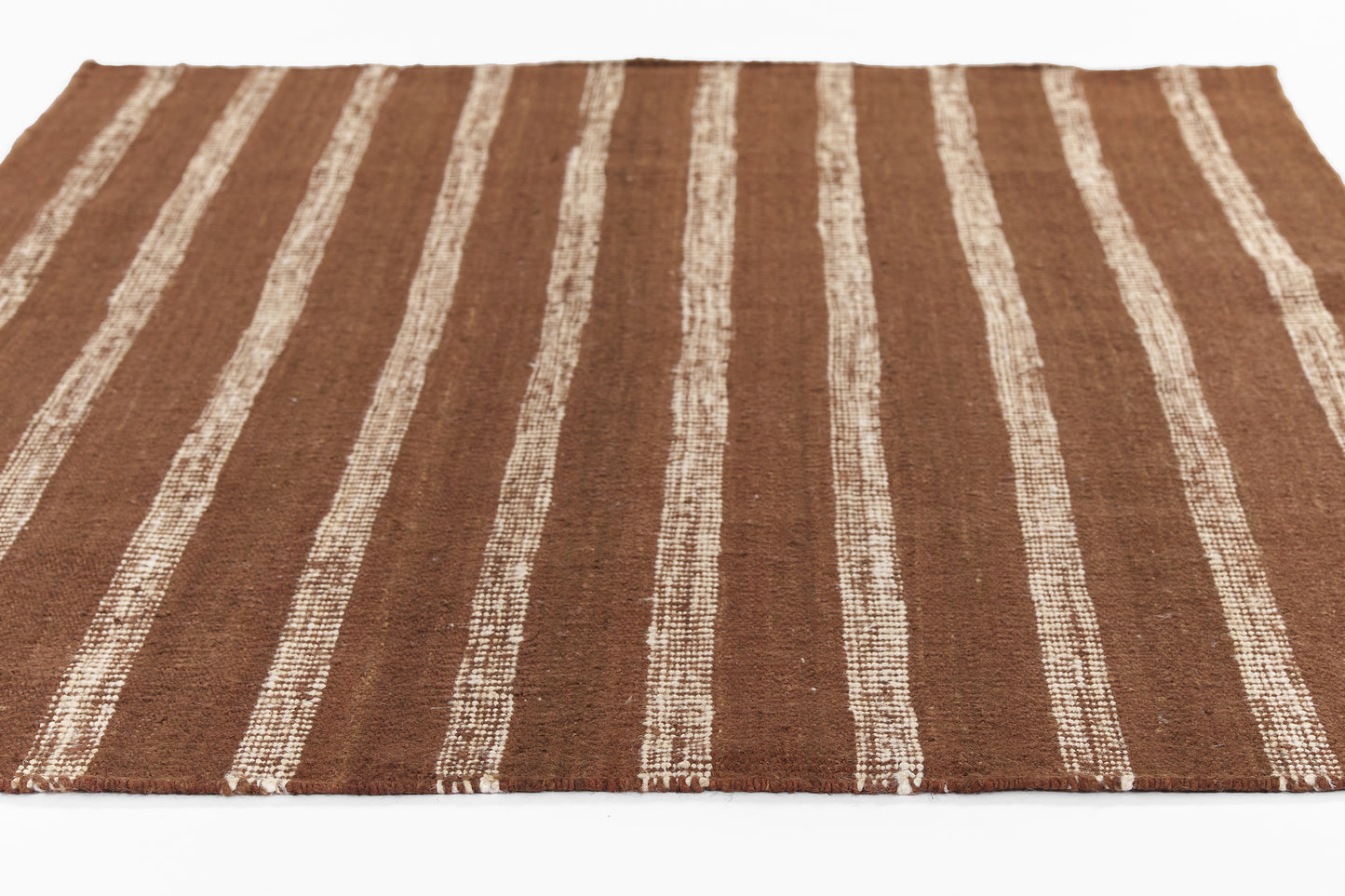 Brown textured rug with cream vertical stripes; flat-weave, rustic boho style for living room.