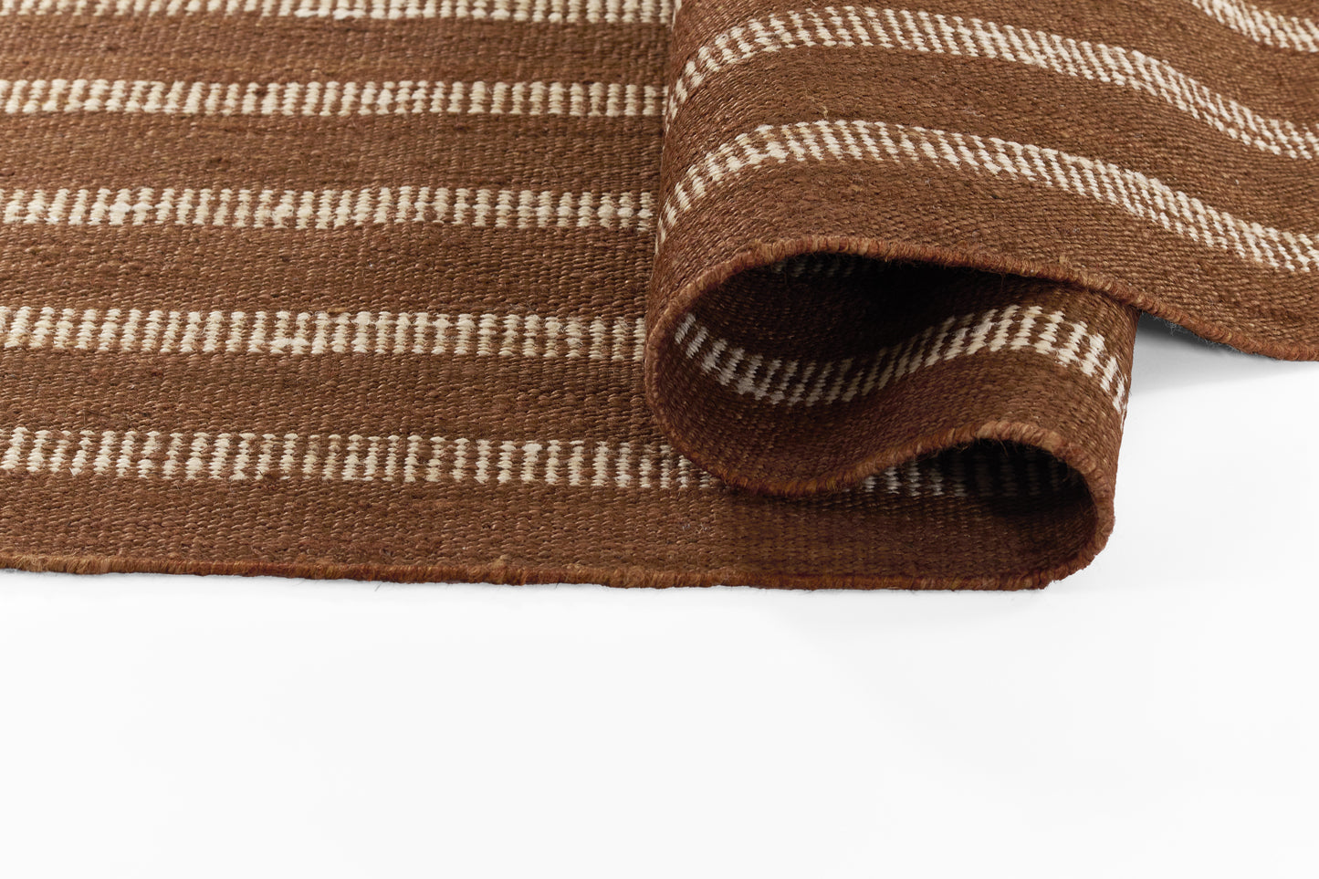 Brown striped woven rug with cream accents, textured chunky weave, folded edge.