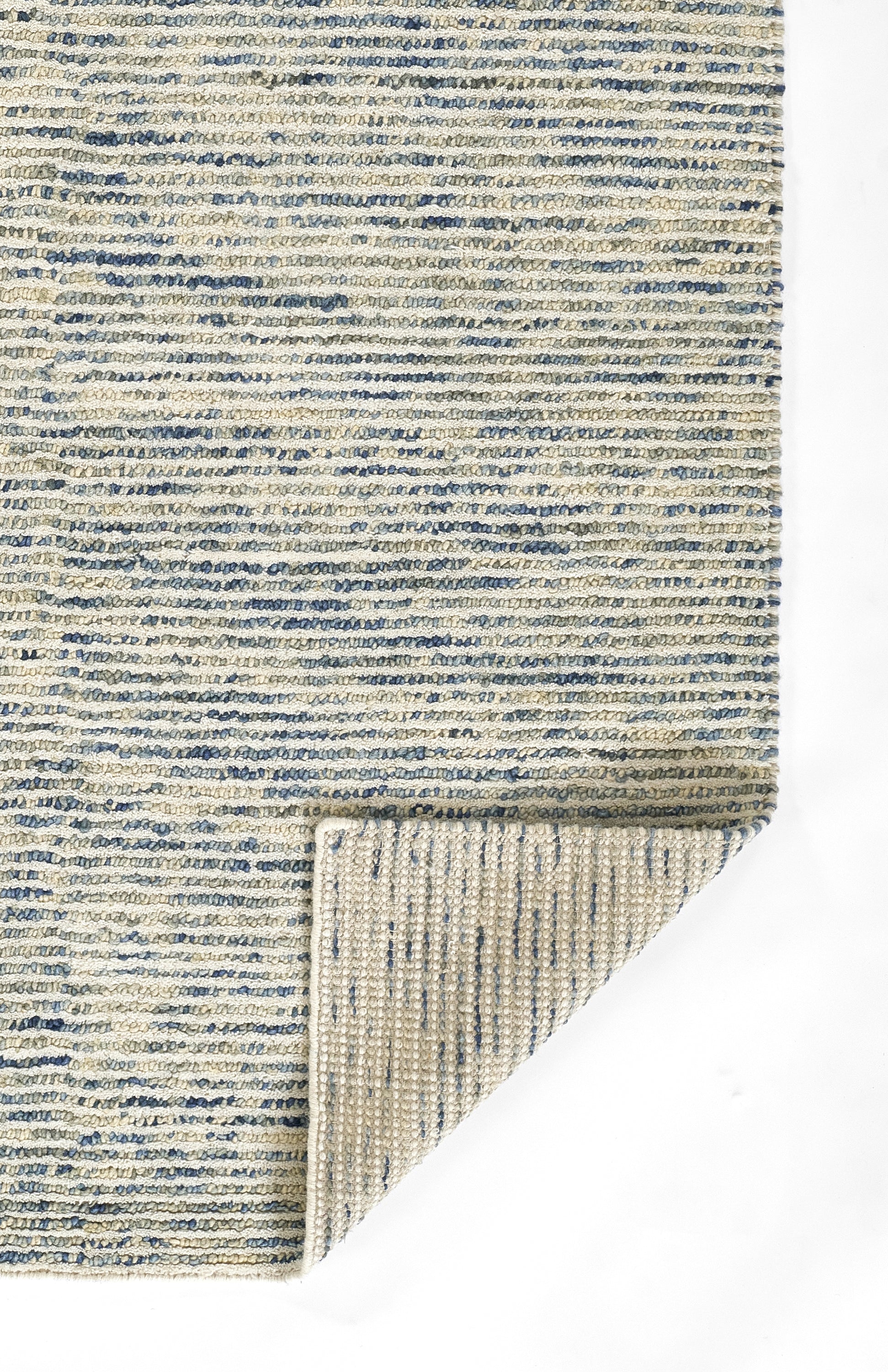 Beige woven rug with blue horizontal stripes; textured short pile, folded corner showing the back.