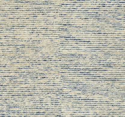 Beige woven rug with subtle blue horizontal stripes; textured flat-weave, casual coastal style.
