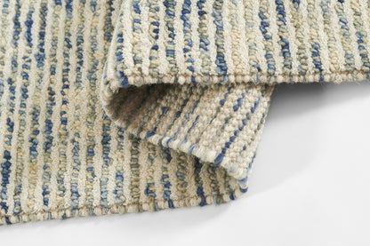 Beige and blue striped boucle rug, folded corner; textured woven home decor.