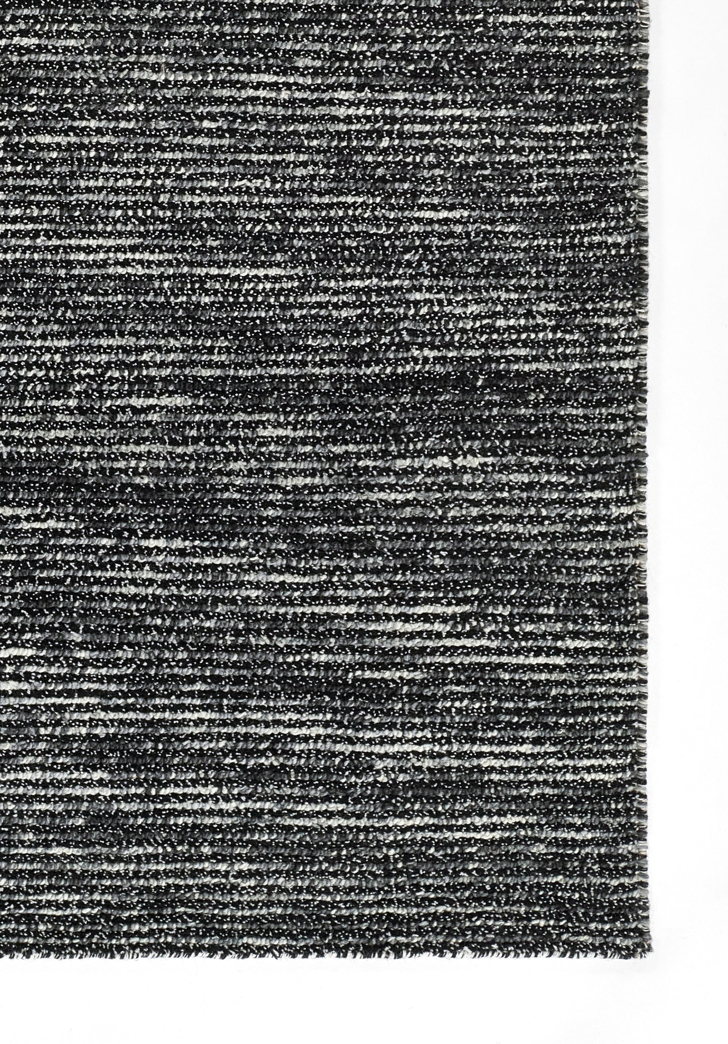 Dark gray heathered rug with a textured woven surface; contemporary chic, versatile for living rooms.